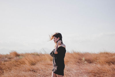 Silhouette of woman standing on field