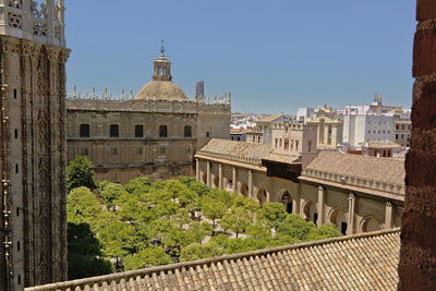 Buildings in city against clear blue sky