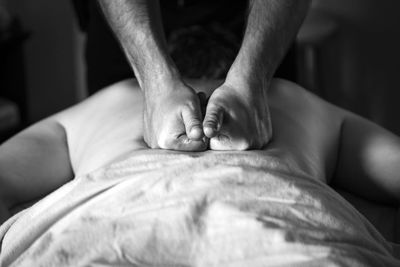Cropped image of therapist massing patient back at spa