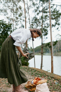 Side view of woman sitting on table