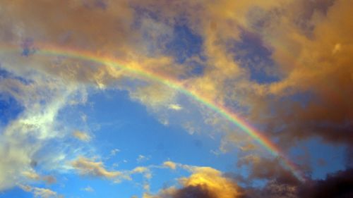 Low angle view of rainbow against sky