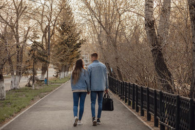 A couple blurred in motion walks in the park in spring or autumn, happy lifestyle concept