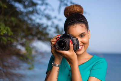 Portrait of woman photographing