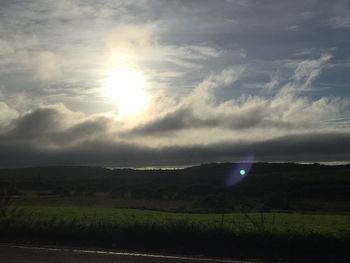 Scenic view of landscape against cloudy sky