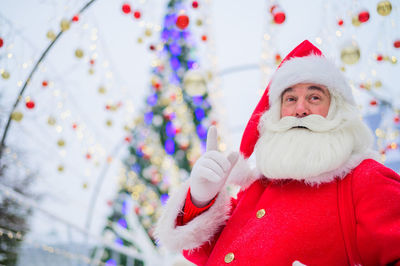 Portrait of santa clause standing outdoors