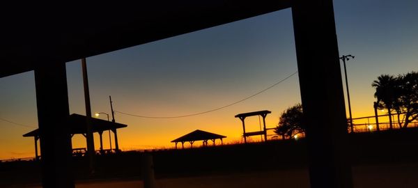 Silhouette built structure against sky during sunset