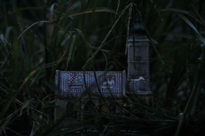 Close-up of abandoned sign on field