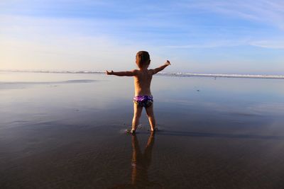 Baby standing on beach
