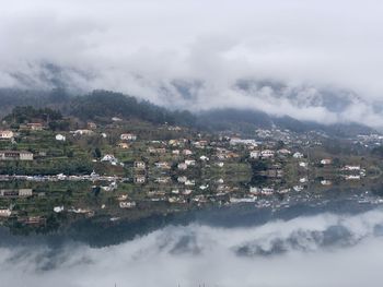 High angle view of townscape by sea against sky