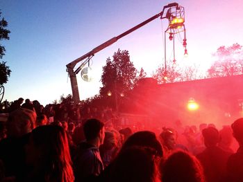 Crowd at music concert against sky