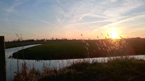 Scenic view of field against sky during sunset