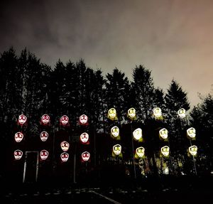 Illuminated lights against sky at dusk