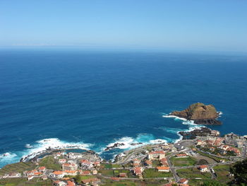 High angle view of sea against blue sky