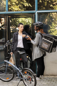 Portrait of young woman riding bicycle on street