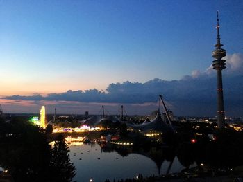 Illuminated buildings in city against clear sky