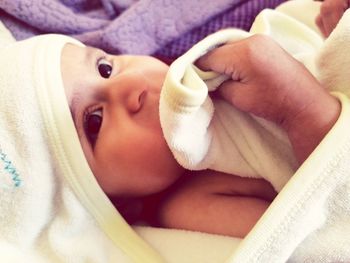 Close-up of baby boy lying in blanket