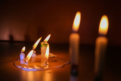 Close-up of illuminated candles on table