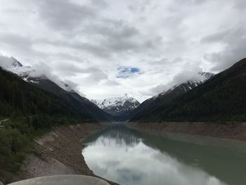 Scenic view of mountains against cloudy sky