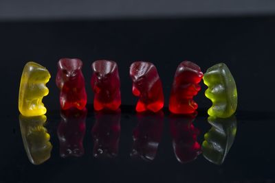 Close-up of multi colored candies against black background