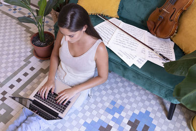 High angle view of woman playing guitar