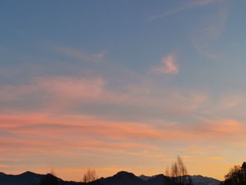 Low angle view of silhouette mountain against dramatic sky