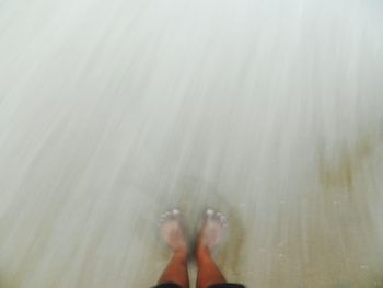 Low section of person standing on tiled floor