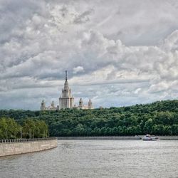 View of cathedral in city against cloudy sky