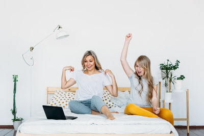 Happy young woman sitting at home