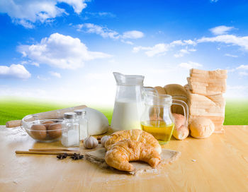 High angle view of croissant and ingredients on table against sky