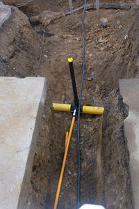 High angle view of yellow umbrella on rock