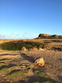 Scenic view of land against clear sky