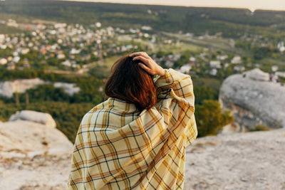 Rear view of woman standing outdoors