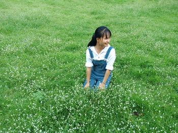 High angle view of woman sitting on grass