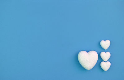 High angle view of heart shape over blue background
