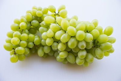 Close-up of grapes over white background