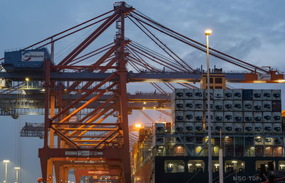 Illuminated commercial dock against sky in city