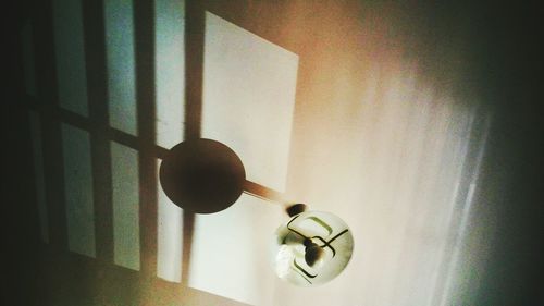 Close-up of electric lamp hanging at home