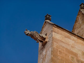 Low angle view of statue against blue sky