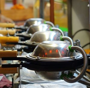 Close-up of waffle irons at food market