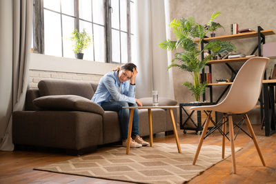 Man sitting on chair at home