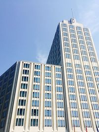 Low angle view of office building against blue sky