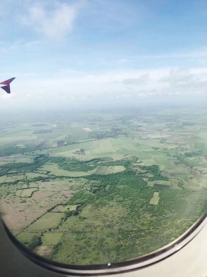 AERIAL VIEW OF LANDSCAPE SEEN THROUGH AIRPLANE WINDOW