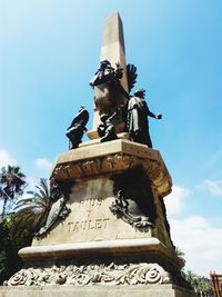 Low angle view of statue against sky