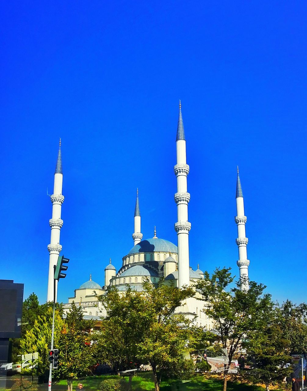 clear sky, blue, building exterior, architecture, religion, built structure, place of worship, copy space, church, spirituality, low angle view, tree, tower, mosque, islam, spire, dome