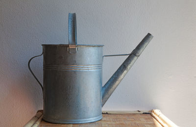 Close-up of pipes on table against wall