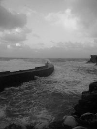 Scenic view of sea against cloudy sky