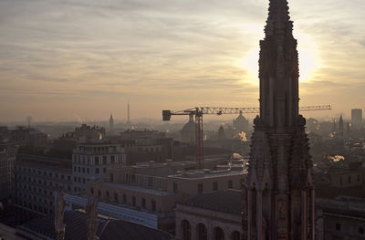 Milan cathedral against cityscape during sunset