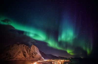 Scenic view of illuminated mountains against sky at night