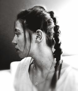 Close-up of woman with braided hair at home