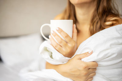 Midsection of woman using mobile phone